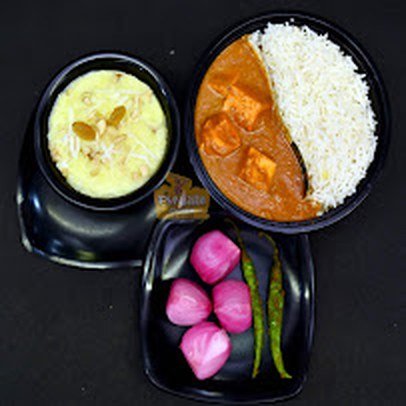 Paneer curry with rice, kheer and pickled onions at Da Punjabi Dhaba